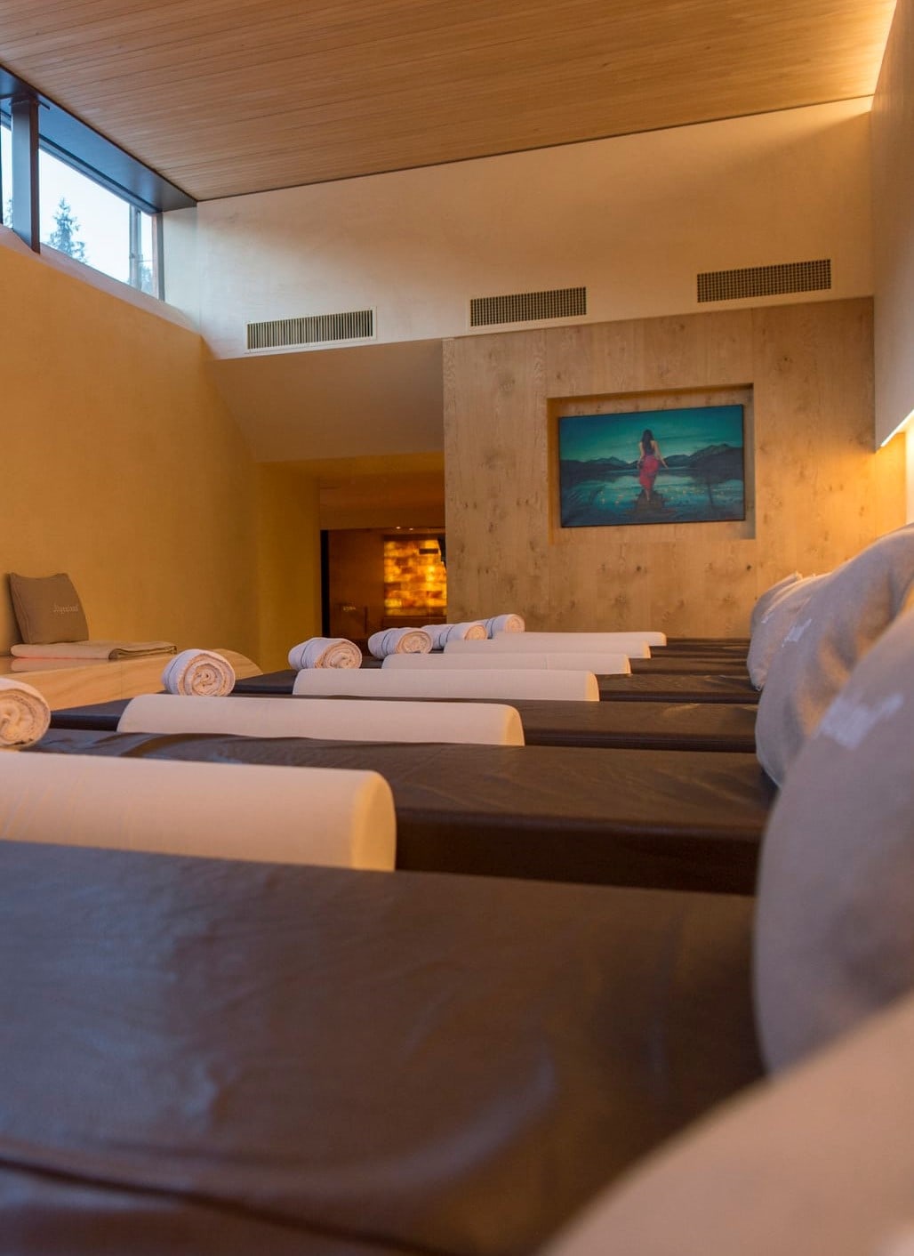A row of several hotel spa beds all set within a modern spa.