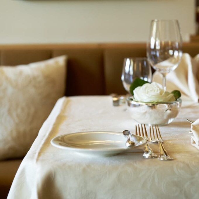 Formal dining room table settings at Hotel Alpenland in Lech.