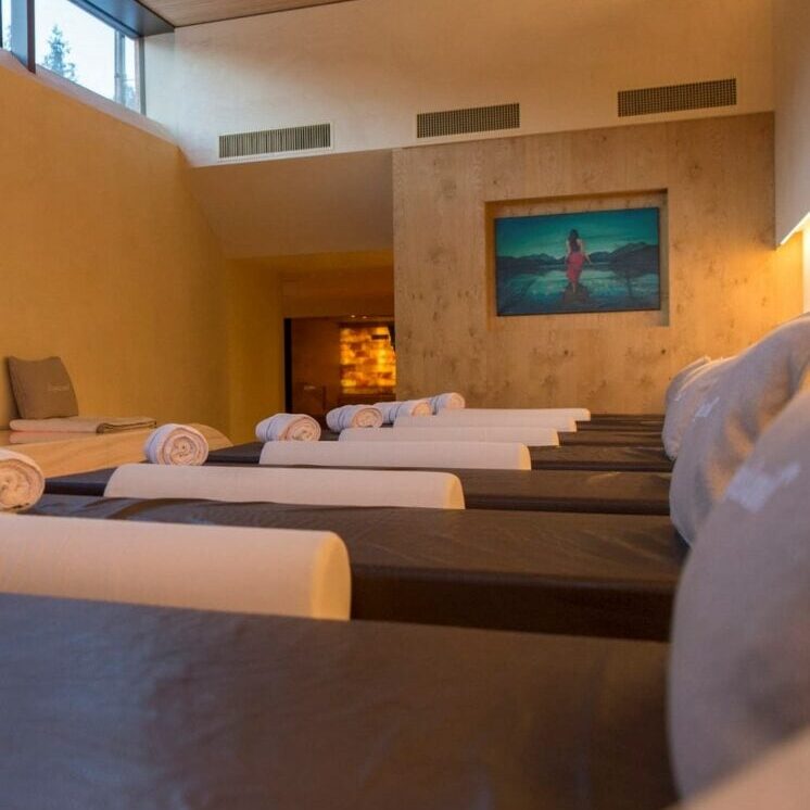 A row of several hotel spa beds all set within a modern spa.